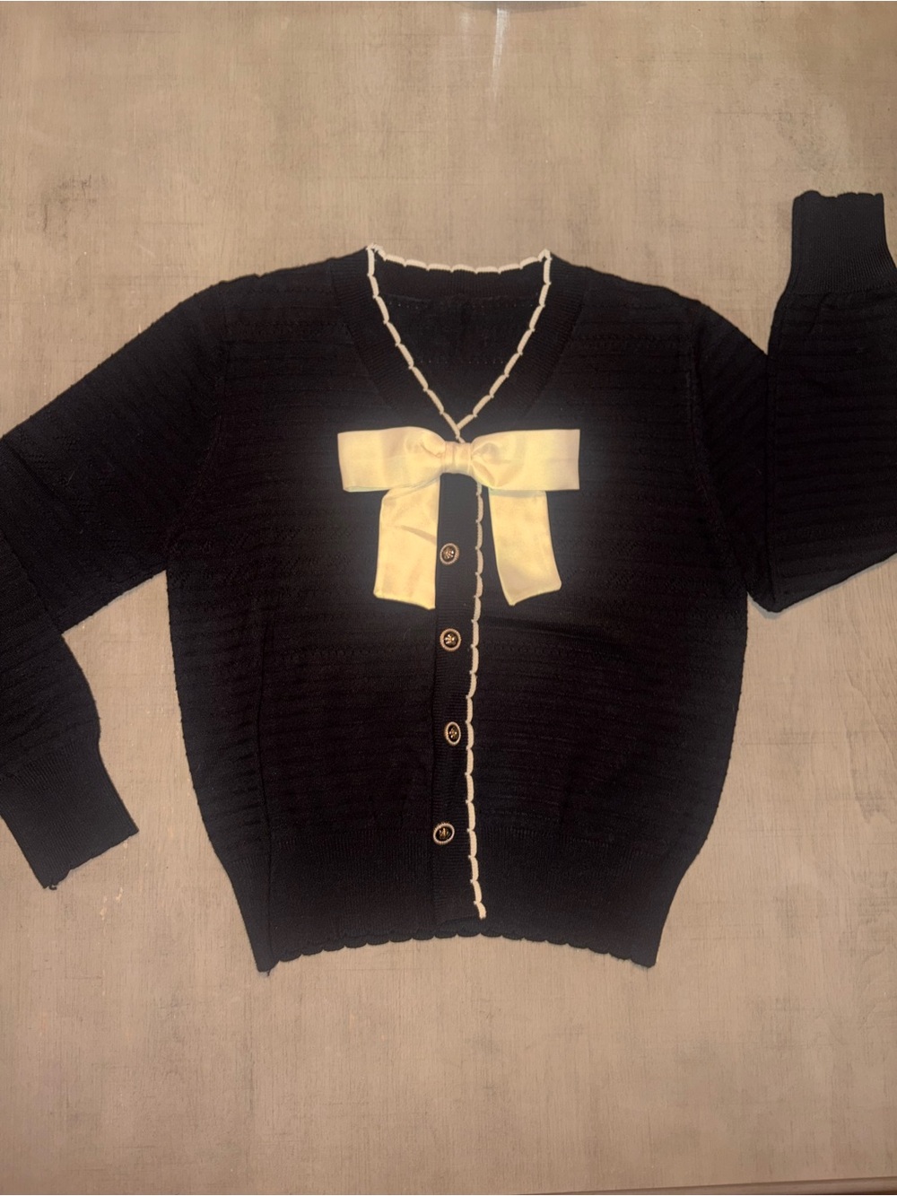 Black V‑Neck Cardigan with Cream Bow Accent